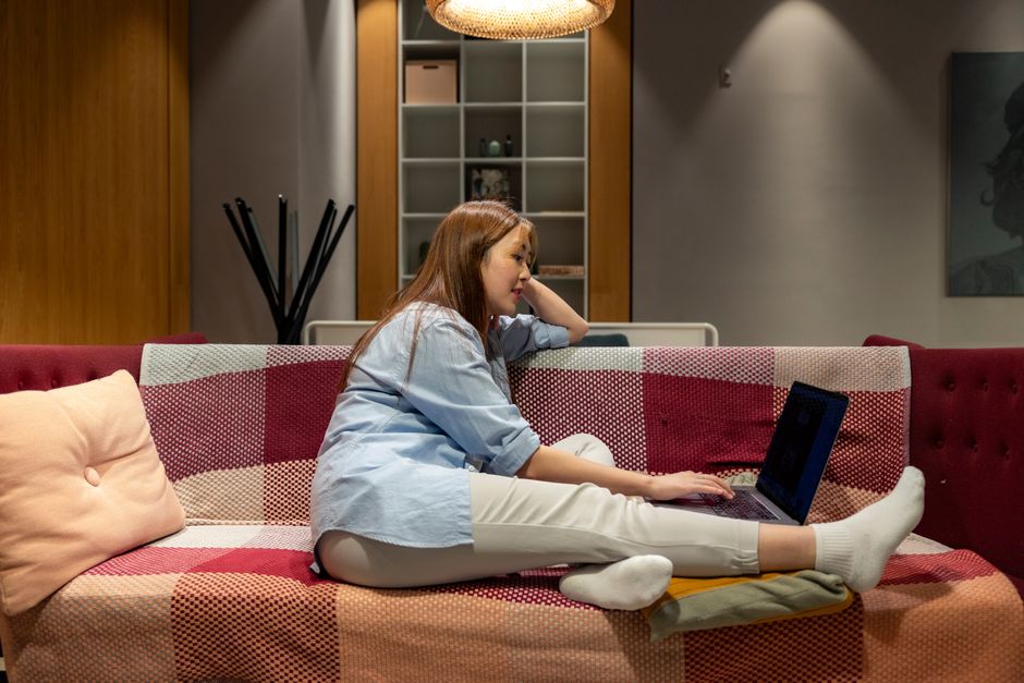 Woman working comfortably from home on a laptop in a relaxed environment